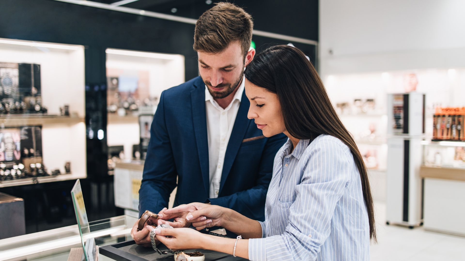 Man and woman examining watches at a jewelry store