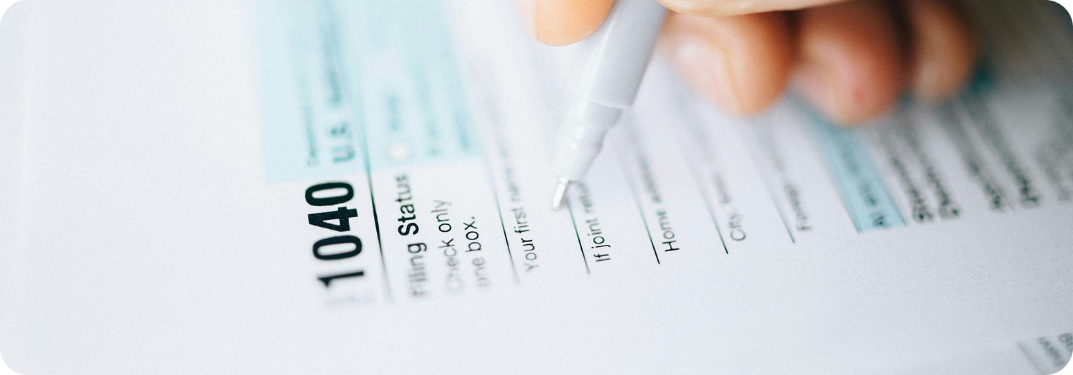 A close up of a 104 tax form with a pencil poised over it